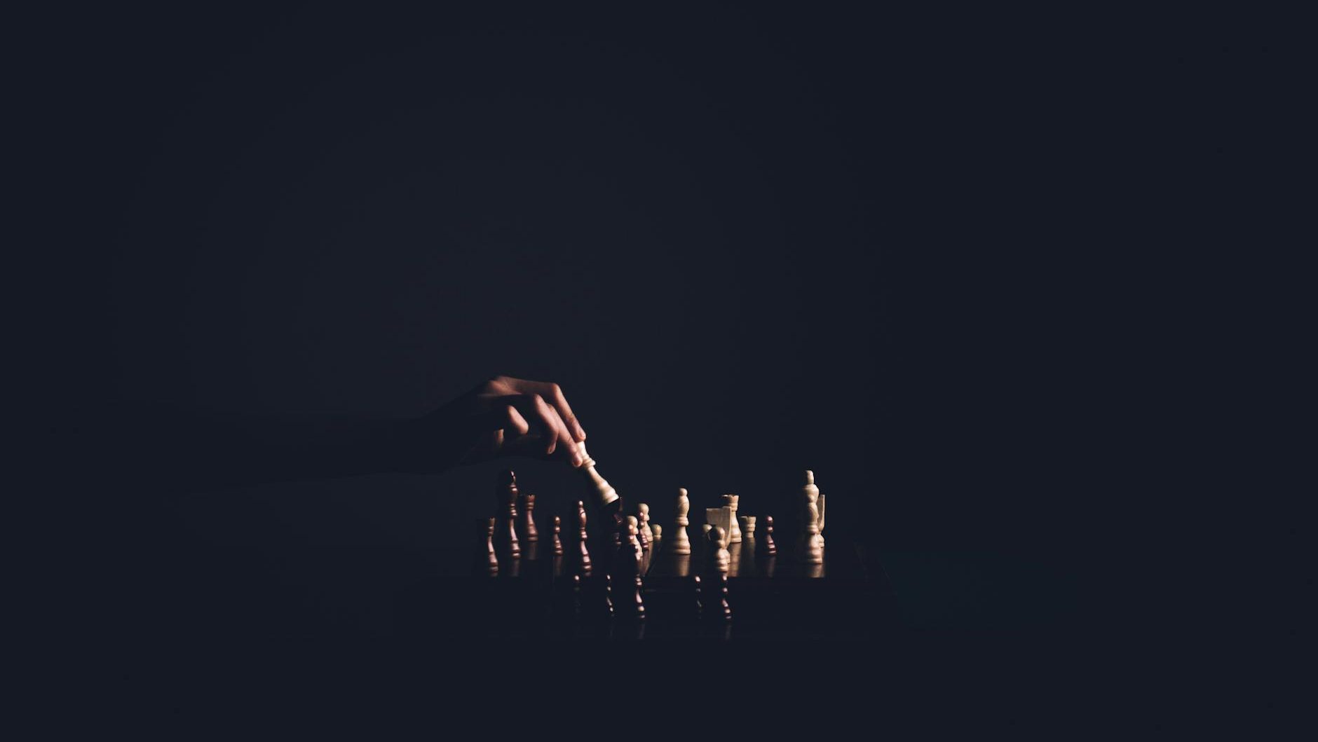person holding chess piece