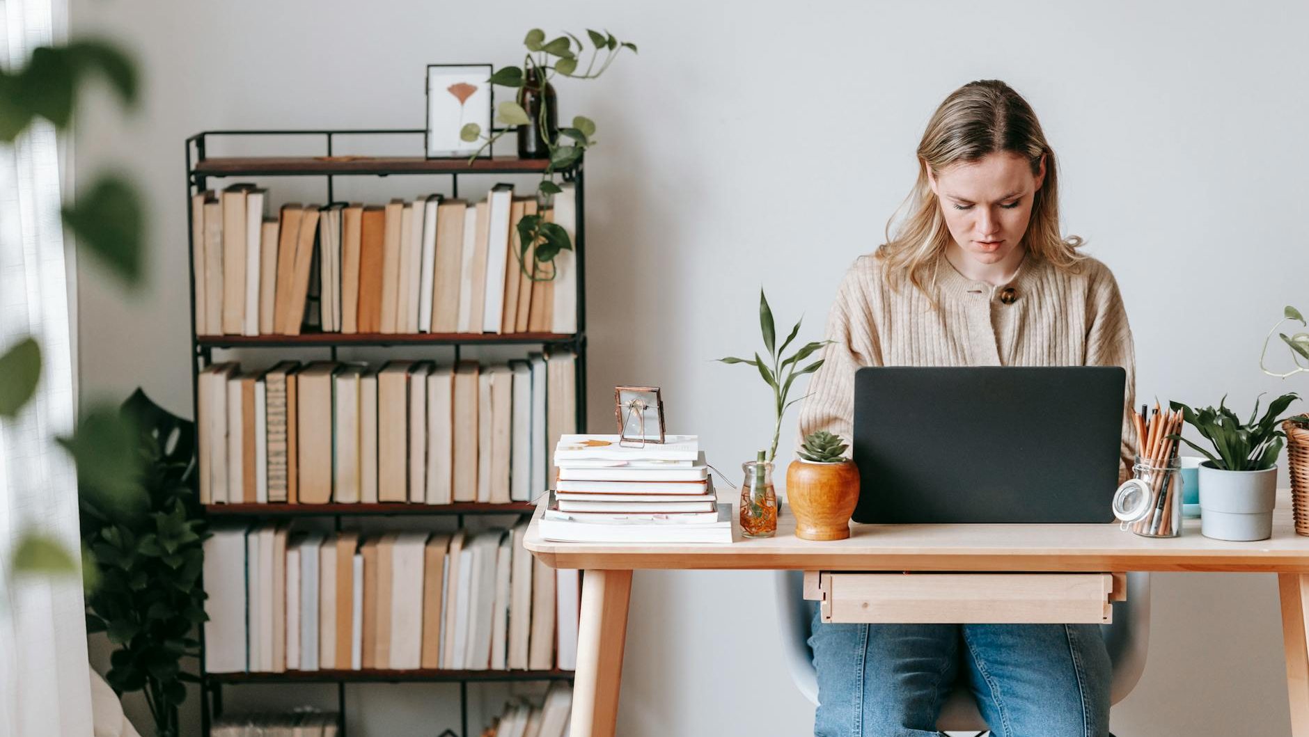 concentrated freelancer working on laptop at home desk