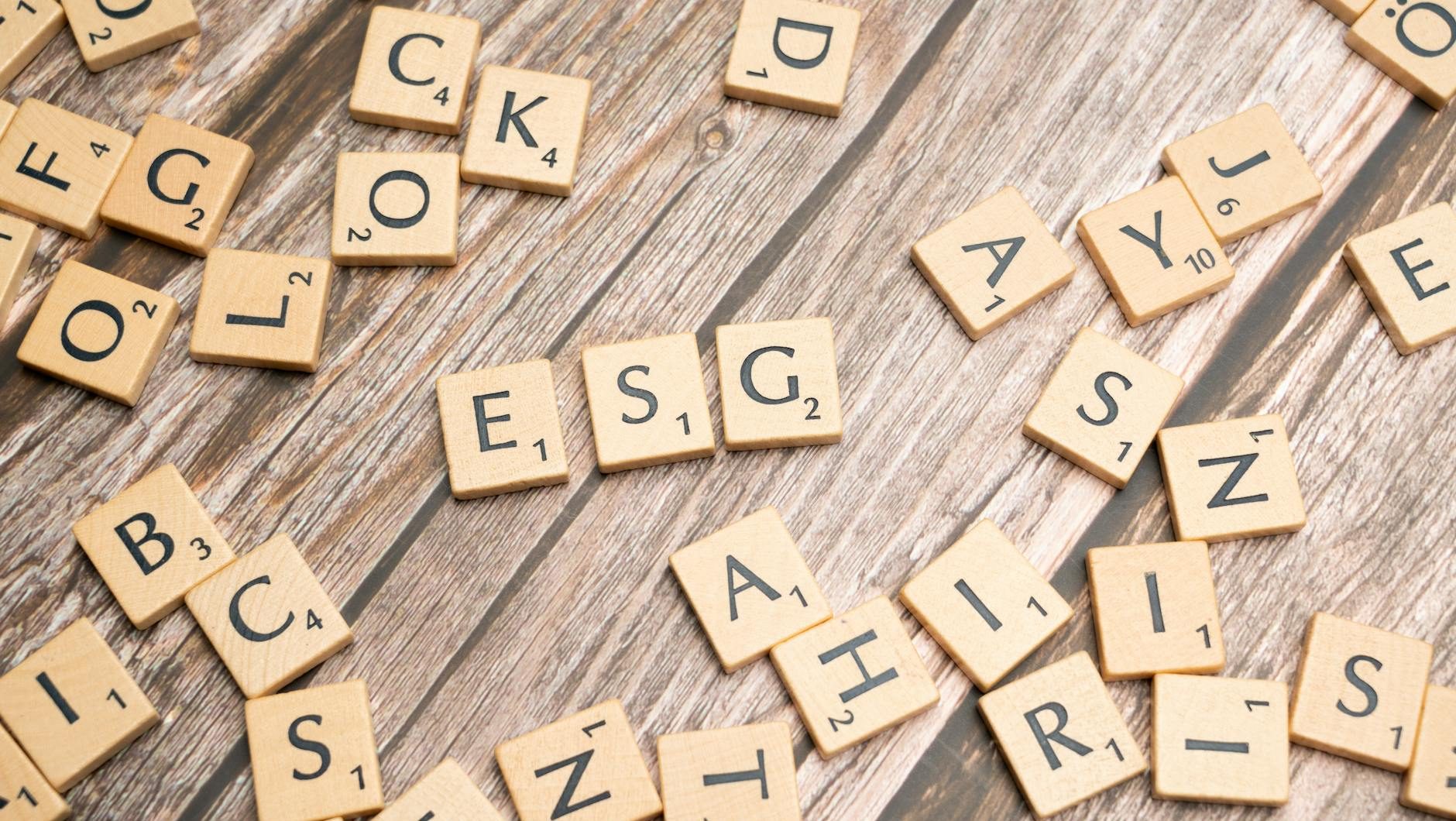 scrabble tiles on a wooden table with the word rock