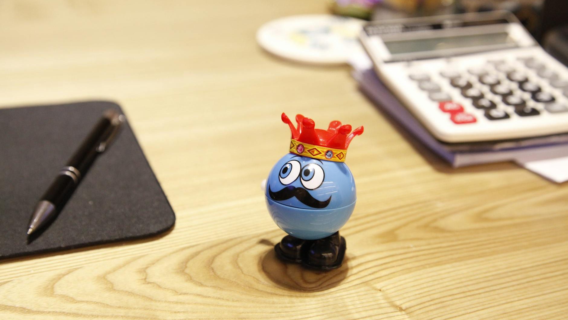 blue round plastic toy on a desk