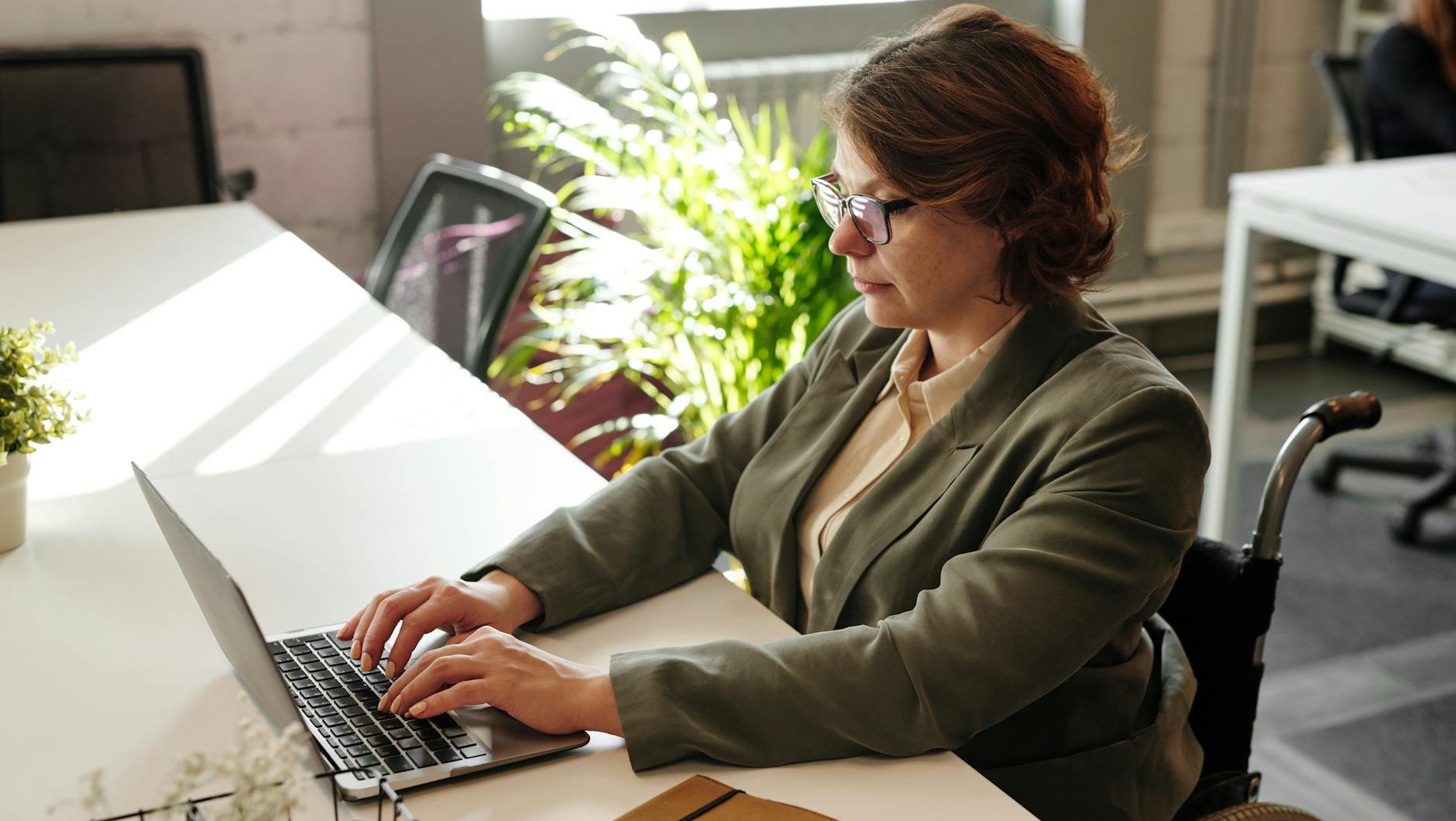 a woman in eyeglasses while using laptop