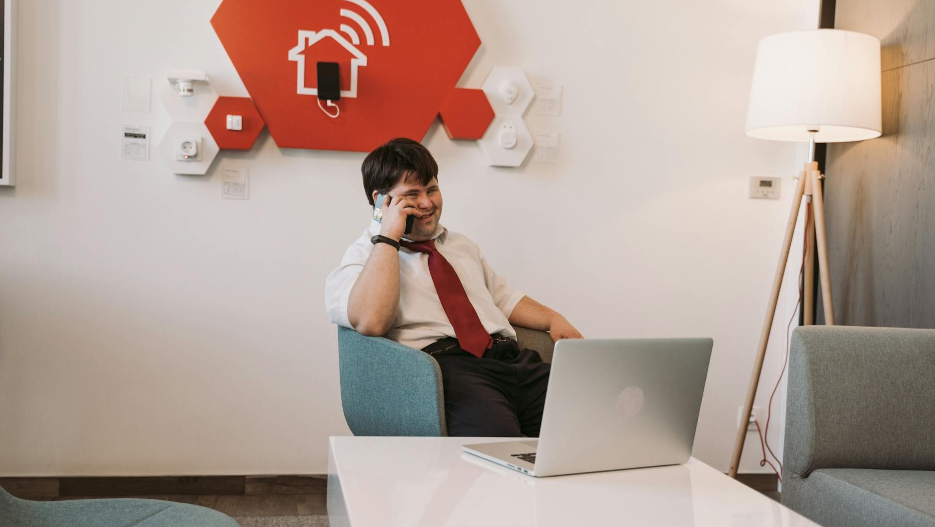 man sitting on chair while having a phone call